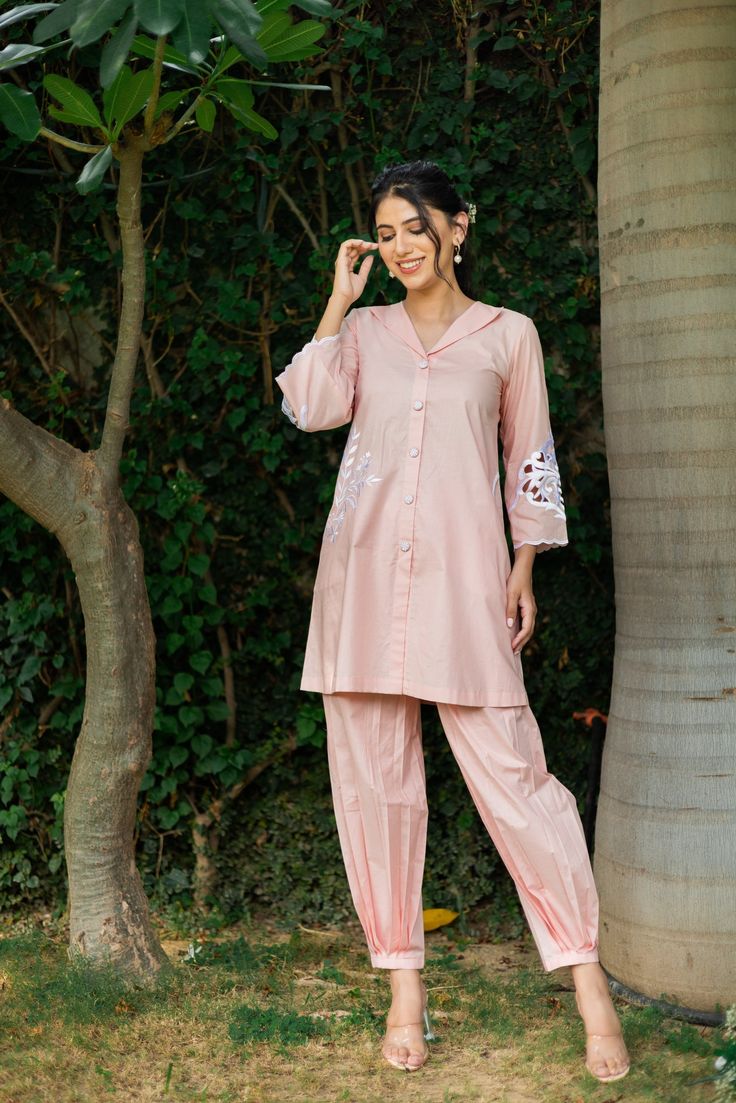 PRODUCT DETAIL: This co-ord set is perfect for any semi-formal and formal occasion. It looks trendy and smart for all age groups. The sleeves have a bold cutwork motif. The shirt is highlighted by circular side pockets and a thread embroidery motif on one side. It is a must-have in your wardrobe!  *The length of the to Eid Long Sleeve Sets With Embroidered Cuffs, Traditional Resham Embroidery Pant Set For Work, Elegant Cotton Sets With Embroidered Cuffs, Embroidered Cotton Palazzo Set With Straight Pants, Festive Embroidered Workwear Pant Set, Festive Embroidered Pant Set For Work, Spring Cotton Sets With Embroidered Sleeves, Cotton Pant Set With Floral Embroidery For Eid, Floral Embroidery Cotton Pant Set For Eid