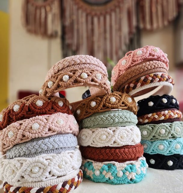 several different colored headbands stacked on top of each other in front of a clock