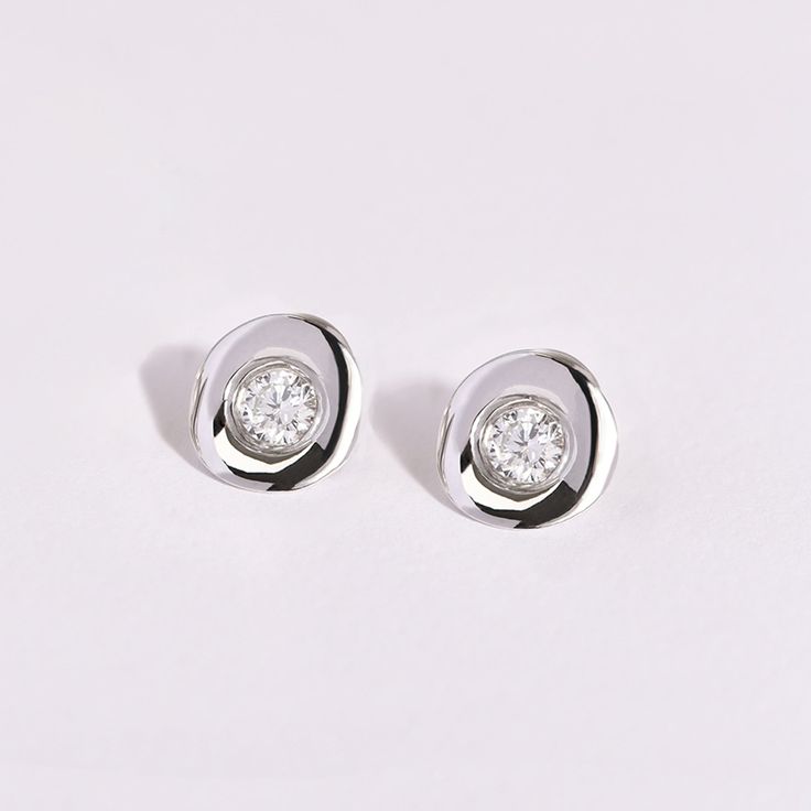 The Volcán Diamond Earrings are made by TANE in sterling silver with 4 round cut lab-grown diamonds with a total carat weight of 1.03. Its geometric figure, inspired by the volumes and shapes of the imposing volcanoes, draws the silhouette of a ring that frames each diamond and highlights its brilliance and purity. As a seal of quality and authenticity, each Diamantes by TANE jewel will feature a lab-grown diamond in TANE"s signature red. TANE diamonds are lab-grown diamonds. Note that the carat Round Cut Diamond, Volcano, Lab Grown, Lab Grown Diamonds, Round Cut, Diamond Earrings, Highlights, Sterling Silver, Pendant