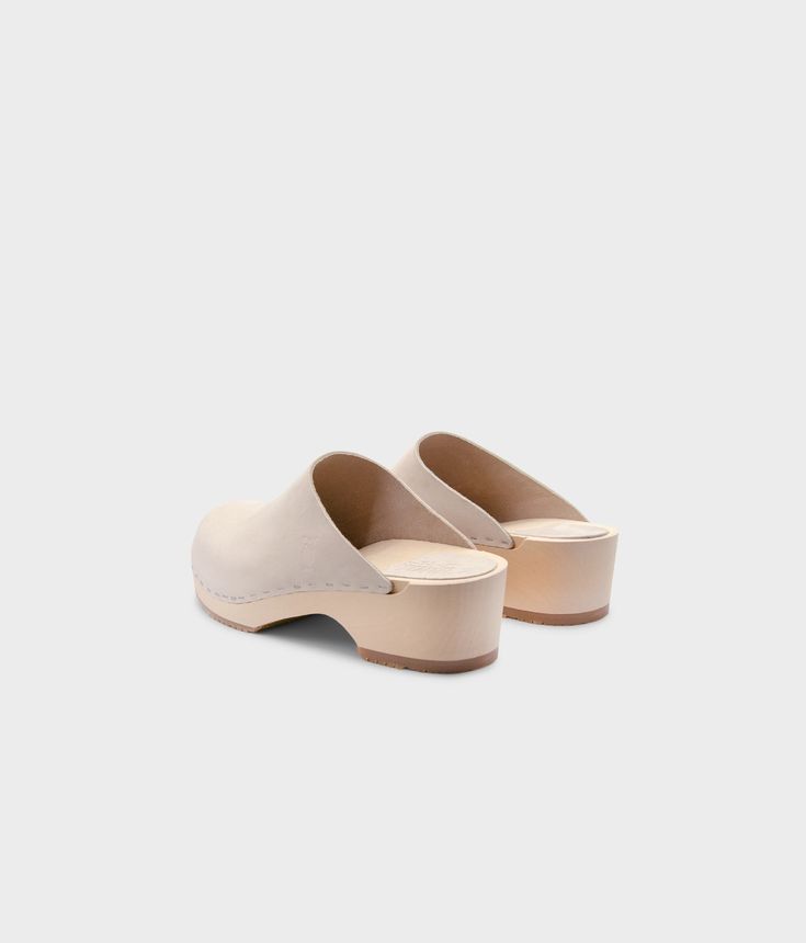 Elevate your everyday style with our minimalist clog mule, featuring clean lines and a timeless aesthetic that effortlessly transitions from day to night. Clog measurements:Heel height: 1 3/4” (4.5 cm)Toe height: 1 5/8″ (4.1 cm) Fit:RegularLeather:Nubuck leather Clogs consist of:Base: European Lime Wood Sole: Rubber sole Fastening: Staples Modern Clogs With Rubber Sole And Open Heel, Modern Open Heel Clogs With Rubber Sole, Casual Mules With Contrasting Heel Counter, Modern Mules With Rubber Sole And Open Heel, Modern Mules With Open Heel And Rubber Sole, Modern Everyday Mules, Everyday Leather Sole Clogs, Classic Clogs With Leather Sole For Everyday, Classic Closed Toe Mules For Everyday