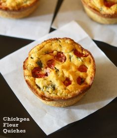 three mini quiche pies sitting on top of white paper