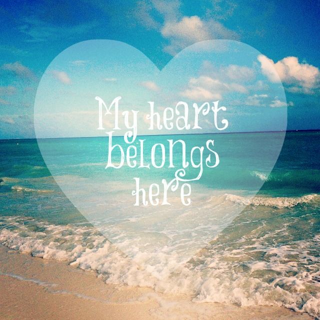 a heart with the words my heart belongs here written on it in front of an ocean wave