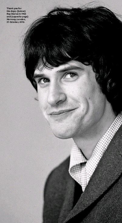 a black and white photo of a man with a smile on his face wearing a vest