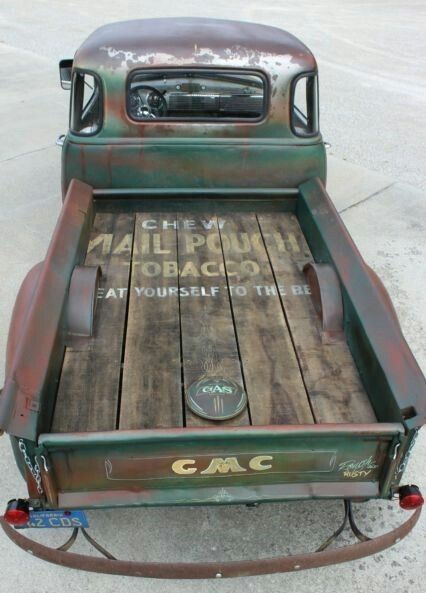 an old pickup truck is parked on the concrete