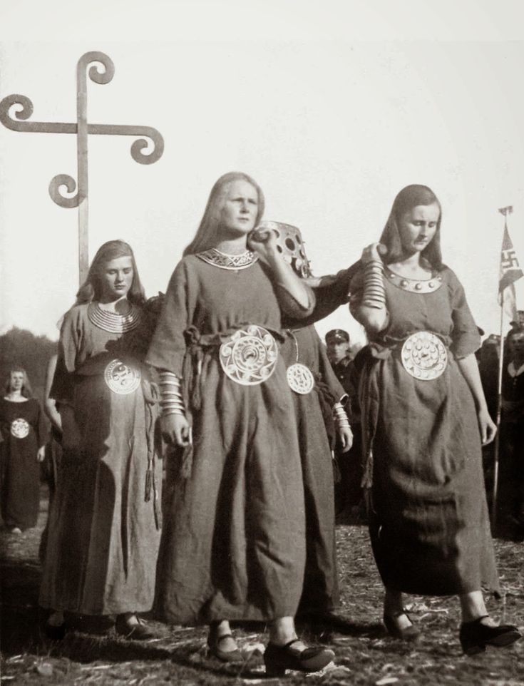 an old black and white photo of two women in medieval dress standing next to each other