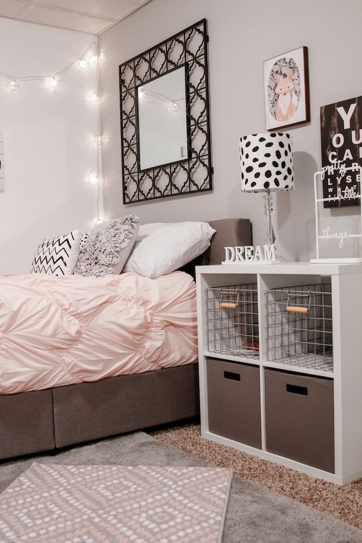 a bedroom with a bed, nightstands and pictures on the wall above it is decorated in black and white