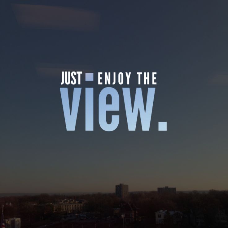 the words, just enjoy the view are displayed in front of a cityscape