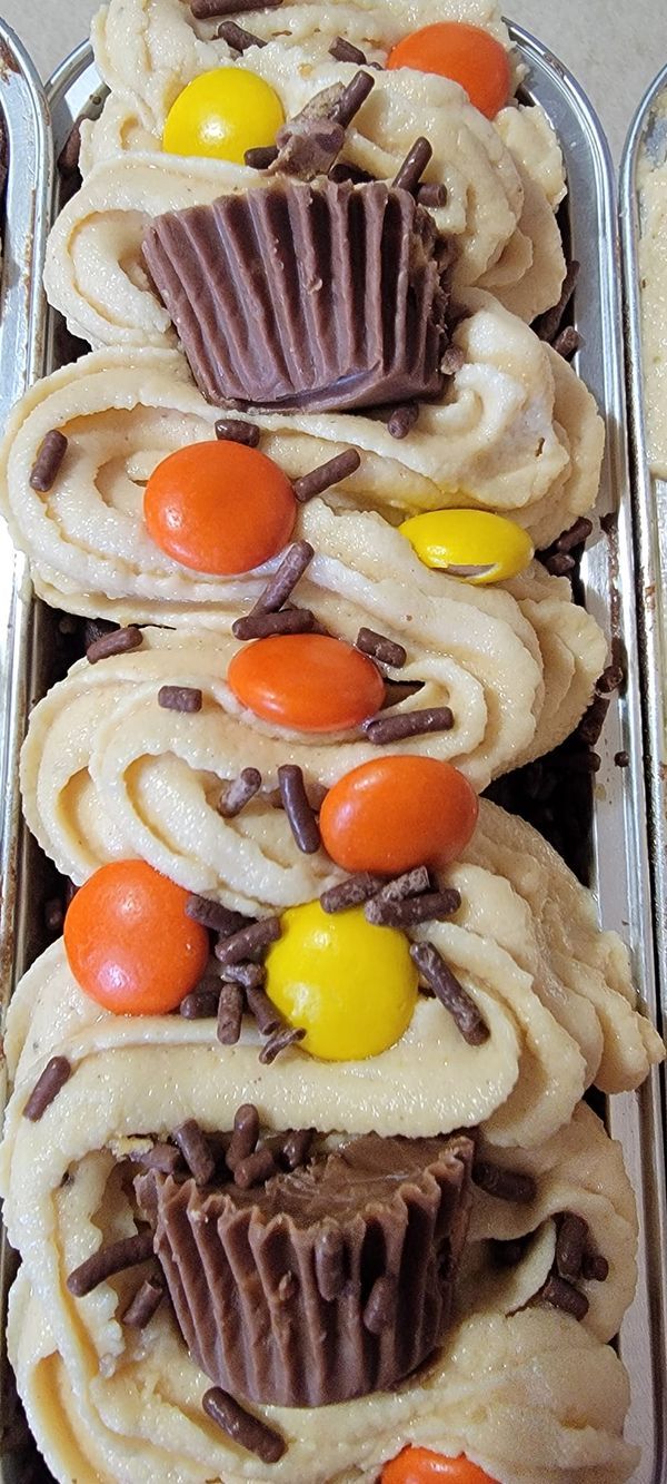 cupcakes decorated with candy and candies in tins