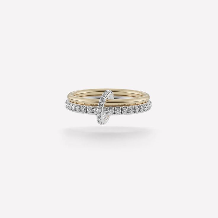 The Astrid SG Gris is comprised of two linked bands in mixed metals of 18k yellow gold and .925 sterling silver, further enhanced by pavé-set gray diamond accents for a dazzling display. Lightweight and comfortable, the Astrid SG Gris is the perfect subtle statement of luxury. Each Astrid SG Gris is individually handmade in downtown Los Angeles. Bands: 18k yellow gold, .925 sterling silver 1.7mm gauge 18k yellow gold band 2.3mm gauge .925 sterling silver band Stones: Gray diamonds (approx. 0.83 Spinelli Kilcollin Wedding Band, Linked Rings, Mixed Metal Ring, Mixed Metal Rings, Gray Diamond, Stone Ornaments, Luxury Jewelry Brands, Shimmer Shine, Luxury Rings