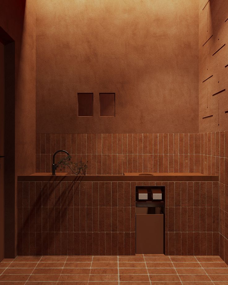 a bathroom with brown tile walls and flooring next to a trash can in the corner