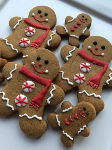 gingerbread men decorated with red scarves and buttons are on the instagram page