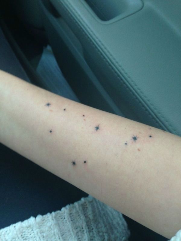 a person's arm with small stars on it