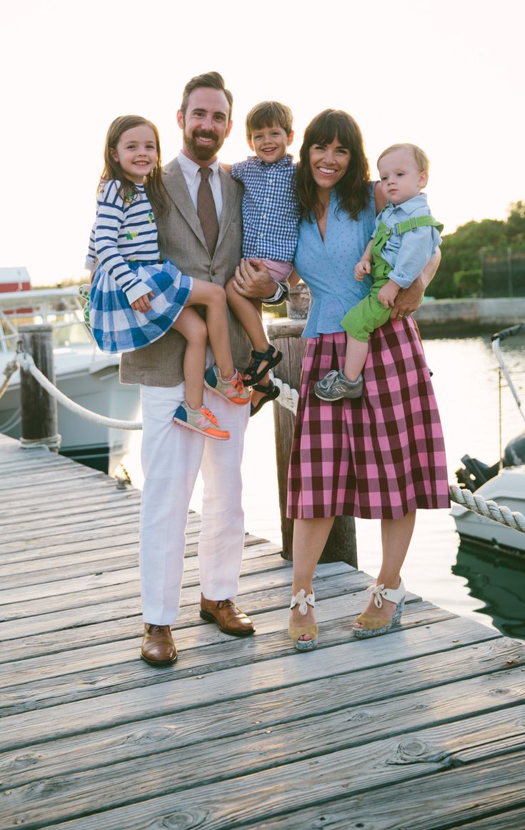 the family is posing for a photo on the dock