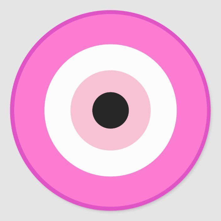 a pink and white circle with a black dot in the center on a gray background