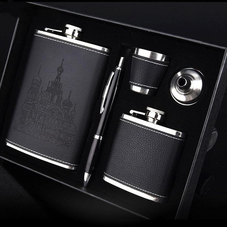 a black leather flask and pen in a gift box with silver trimmings