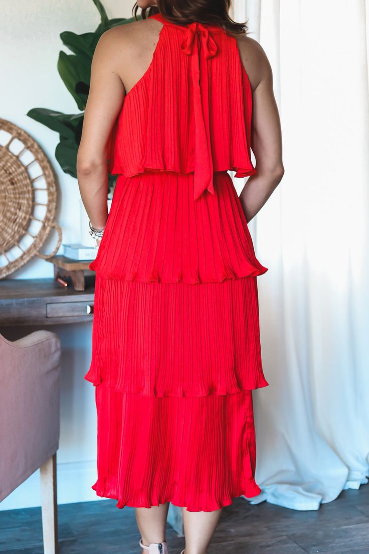 The Bella tiered dress is now back in a bright bold red! Style this beautiful maxi with the pearl belt. Fully Lined High Neck Midi Tired style midi can be styled with belt Pleated tiered Midi Elastic waist band Tie back closure Model is wearing a size Small. She is 5'6". 130lbs. Bust: 34C" Waist 26" Hips 36" Layered Chic Maxi Dress, Chic Layered Maxi Dress, Red Tiered Maxi Dress For Spring, Red Tiered Skirt Maxi Dress For Spring, Red Tiered Ruffle Midi Dress, Red Tiered Maxi Dress With Ruffles, Red Tiered Maxi Dress For Party, Red Tiered Midi Dress With Ruffles, Red Tiered Midi Dress For Spring