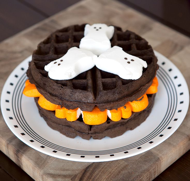 a chocolate waffle topped with marshmallows and ghost decorations