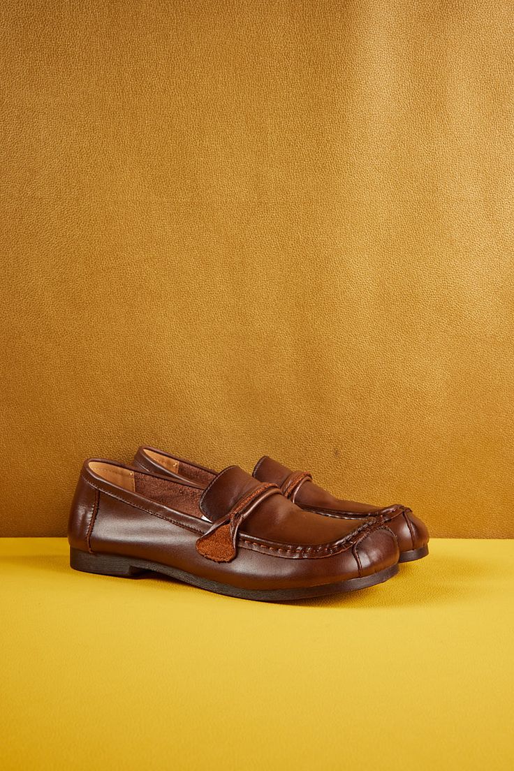 Introducing Rumour Has It's Serious Leisure Leather Loafer in classic brown. Crafted with premium leather, this loafer combines style and comfort for a truly versatile shoe. Whether you're dressing up for a formal event or keeping it casual, this loafer will elevate any look with its sleek design and all-day comfort. 0.98" heel Pull-on Leather upper Leather lining Leather footbed Rubber sole Slip-on Brogue Detailed Closed Toe Moccasins, Slip-on Brogue-detailed Closed Toe Moccasins, Slip-on Brogue Moccasins With Closed Toe, Business Casual Brogue-detailed Slip-on Moccasins, Slip-on Closed Toe Moccasins With Brogue Detailing, Business Casual Slip-on Moccasins With Brogue Detailing, Brown Swift Leather Slip-ons With Textured Sole, Brown Leather Tassel Loafers With Closed Toe, Classic Brown Loafers With Textured Sole