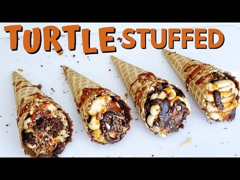 there are four desserts in cones on the white plate that says turtle - stuffed