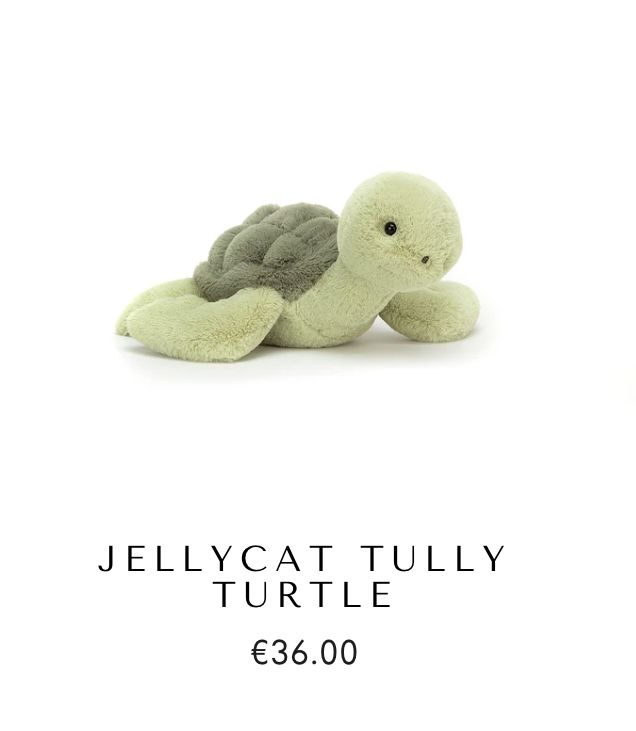 a small stuffed turtle sitting on top of a white background with the words jellycat tully