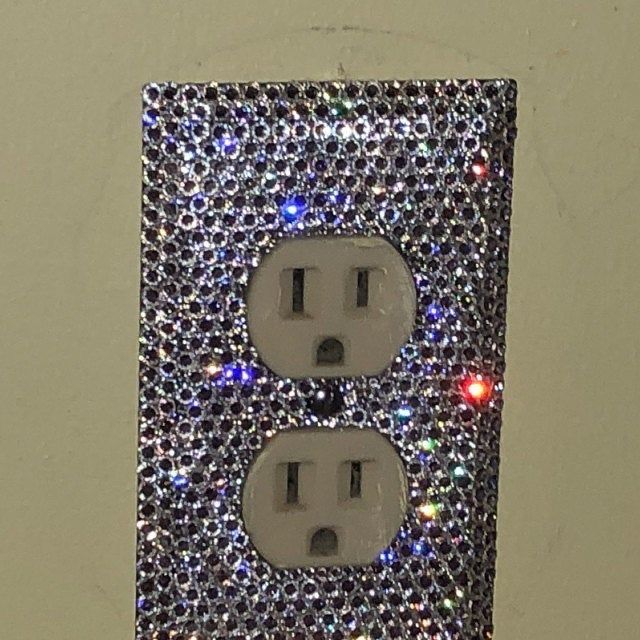 the light switch is decorated with multicolored lights