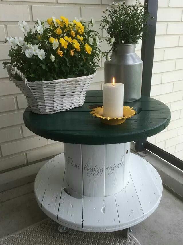 a table with flowers and a candle on it