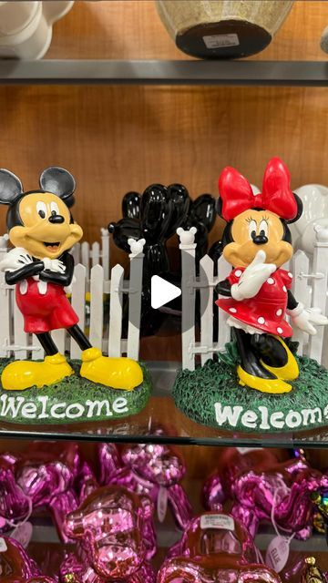 mickey and minnie mouse figurines are on display