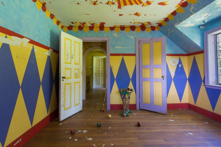 an empty room with blue, yellow and red painted walls