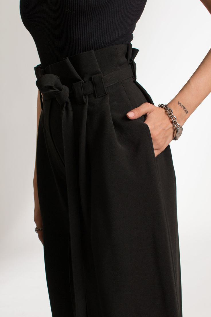 The Amorusso Pants are a high-rise, wide leg trousers, crafted from a cotton blend. The pants offer a flattering fit around the waist and hips. They come with a long detachable waist belt. These sustainable pants are tailor made and on demand. It takes us 6 hours to make these pants. PLEASE ALLOW 1-3 BUSINESS DAYS FOR PRODUCTION Black High-waist Bottoms With Belt Detail, Black High Waist Bottoms With Belt Detail, High Waist Black Bottoms With Belt Detail, Black Belted Wide Leg Bottoms, Black Wide-leg Bottoms With Belt, Black Wide Leg Bottoms With Belt, Black Straight Leg Pants With Belt, Chic Belted Wide Leg Workwear Pants, Chic Belted High-waisted Wide Leg Pants