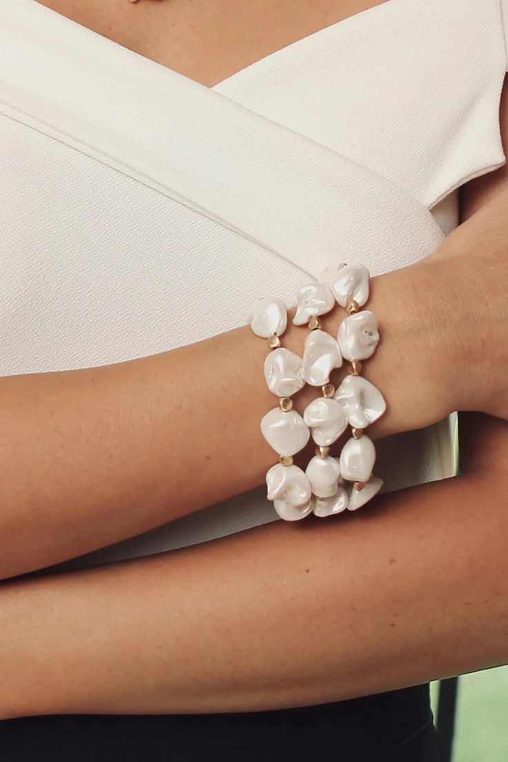 We are over the moon for these organically shaped pearls on our Charlotte Bracelet. Evoking fresh-from-the-sea vibes, this statement bracelet can be from brunch to the beach. With the flexible coils, this bracelet has the added bonus of being effortless to slip on your wrist. Pair with the Charlotte Necklace and Earring or wear solo! Materials: Matte Gold Plated, White Seashell Pearl Size: 8" x 2" Magnetic Clasp Imported Matching Necklace and Earrings Sold Separately Clay Bead Bracelet Ideas, Bracelets Clay, Bead Bracelet Ideas, Clay Bead Bracelet, Ideas Jewelry, Beautiful Bracelets, Trendy Bracelets, Daily Jewelry, Clay Bead