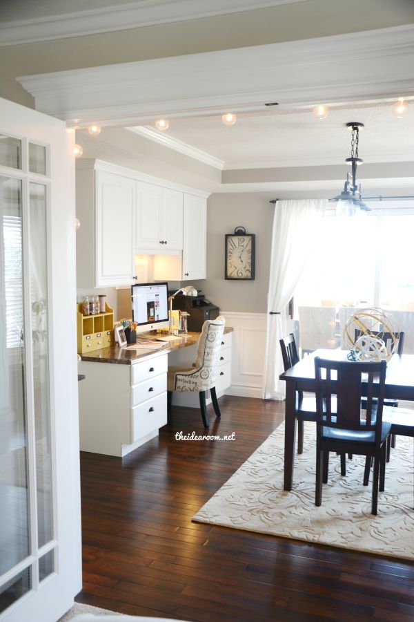 a dining room table and chairs in front of a window