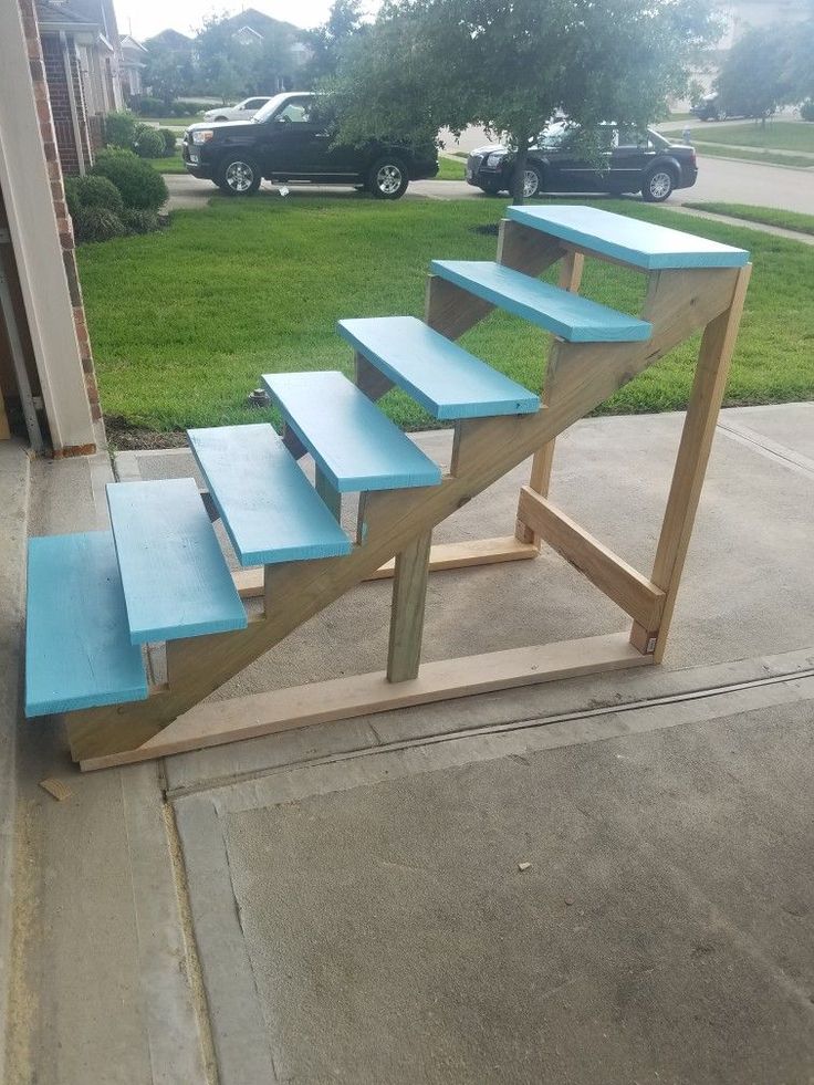 a set of stairs made out of wood and painted blue