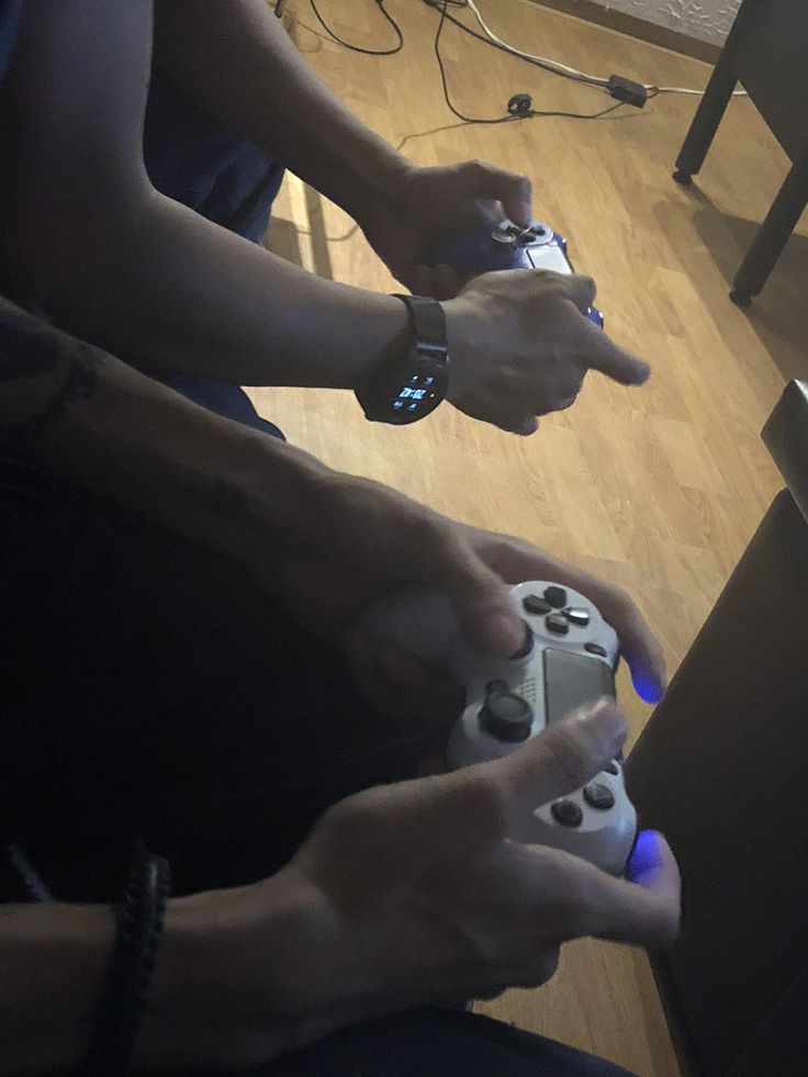 two people holding game controllers in their hands