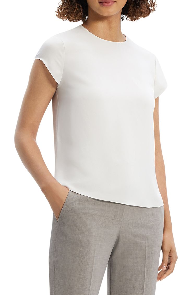 Clean lines elevate a lightweight top made from smooth and beautifully draping silk. Back keyhole with hook-and-eye closure Jewel neck Cap sleeves 100% silk Dry clean Imported White Viscose Formal Tops, Formal White Viscose Tops, Sleek White Formal Tops, Elegant White Viscose Top, Modern Fitted Silk Tops, Modern Silk Tops For Formal Occasions, Silk Crepe Tops For Spring Workwear, Sleek Viscose Tops For Office, Modern Formal Viscose Tops