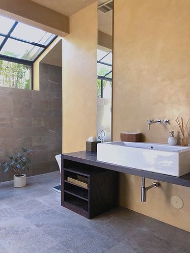 a bathroom with two sinks and a large mirror on the wall next to each other