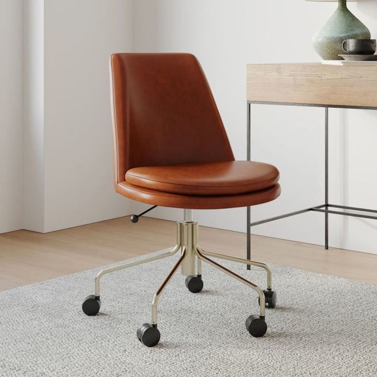 a brown leather office chair sitting on top of a white rug next to a desk