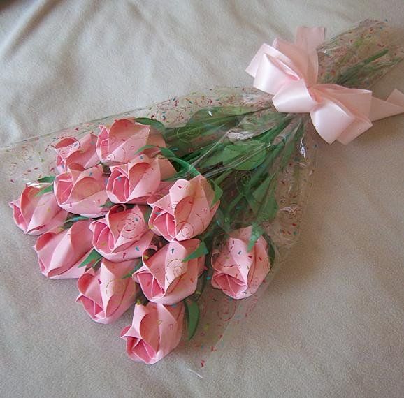 a bouquet of pink flowers on a bed