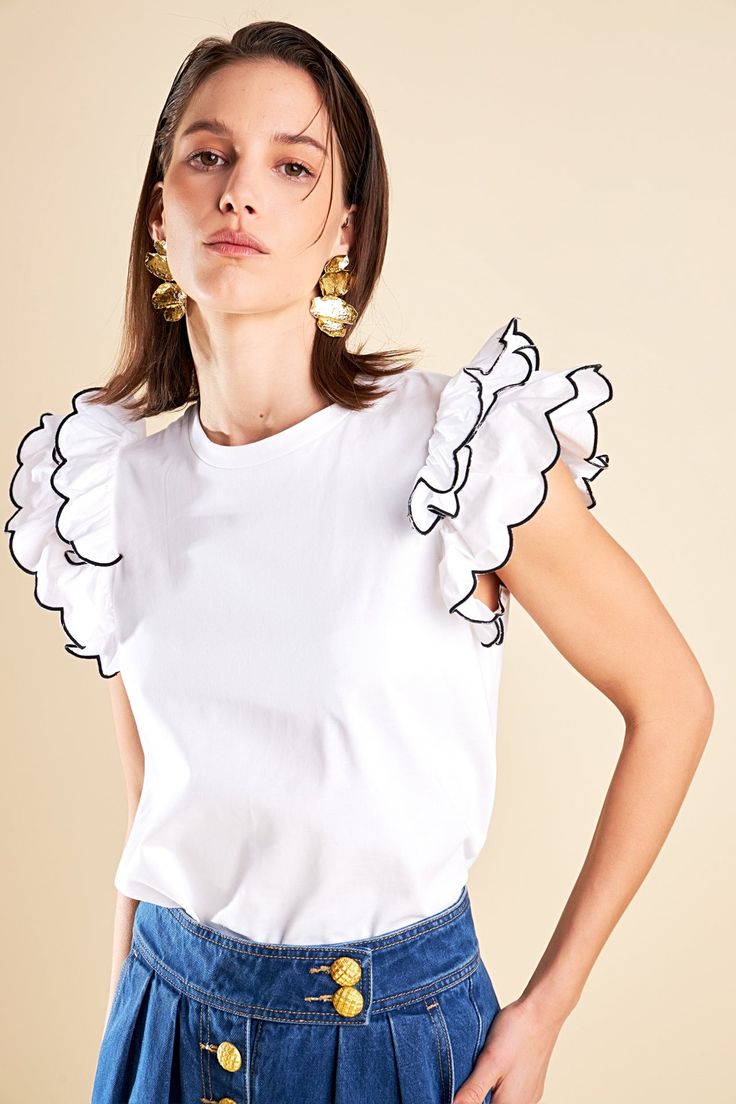 Elevate your wardrobe with our Merrow Stitch Ruffle Top. The rounded neckline adds a touch of femininity while the ruffle shoulder detail adds a playful and trendy touch. The contrast ruffle hem merrow stitch creates a unique and eye-catching look. With a regular length this top is perfect for both casual and dressy occasions. Made with high-quality materials this top is not only fashionable but also comfortable to wear. Perfect for standing out from the crowd our Merrow Stitch Ruffle Top is a m White Top With Ruffled Hem And Straps, White Tops With Ruffles And Ruffled Straps, White Tops With Ruffled Straps, White Trendy Tops With Ruffled Straps, White Tops With Ruffled Straps And Details, White Trendy Top With Ruffled Straps, Chic White Ruffled Top, White Ruffled Flutter Sleeve Tops, Chic Crew Neck Tops With Ruffle Hem