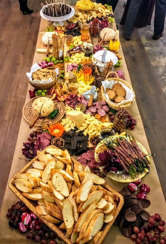 a long table filled with different types of food and snacks on it's sides