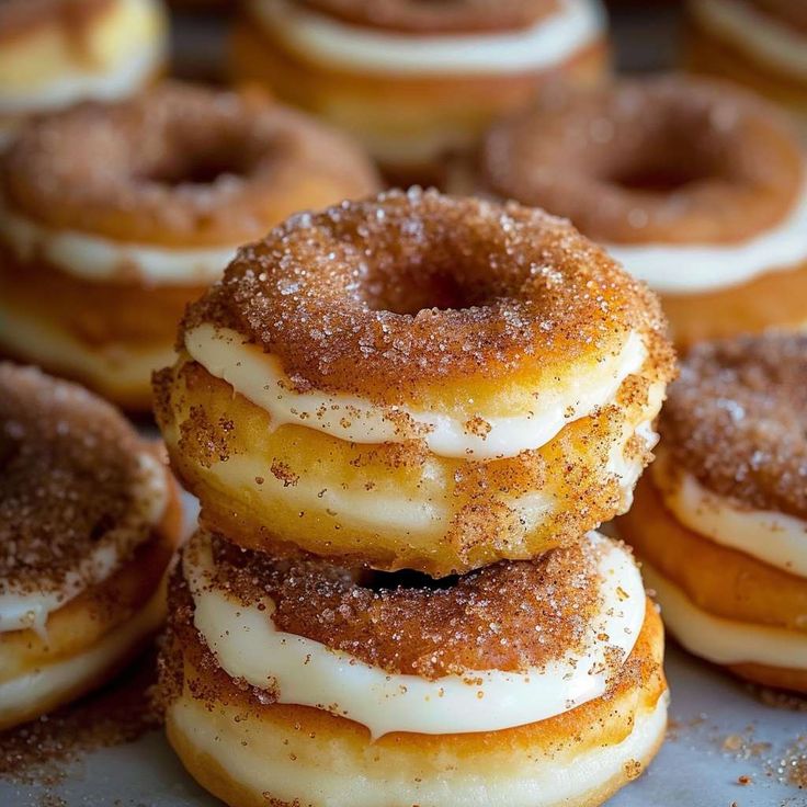 several glazed donuts stacked on top of each other with sugar sprinkles