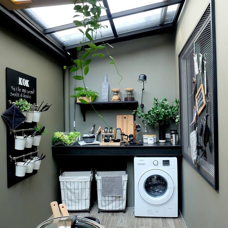 a laundry room with a washing machine and plants