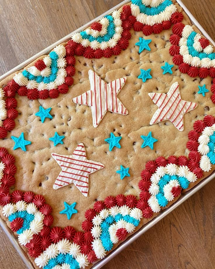 a cookie decorated with red, white and blue stars on top of a wooden table