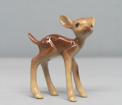 a small deer figurine sitting on top of a table