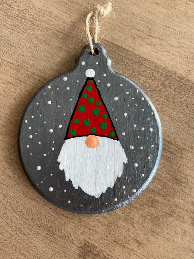 a wooden ornament with a santa clause on it's face and polka dots