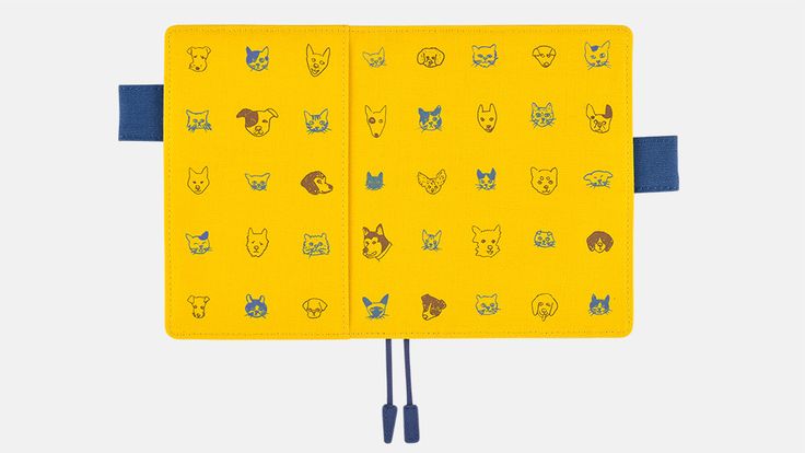 a yellow notebook with cats and dogs drawn on it, tied to a blue cord