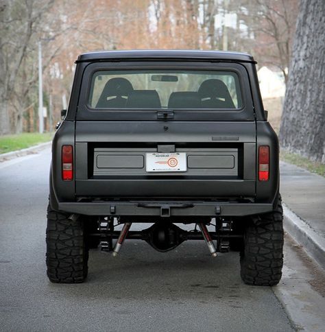 a black truck parked on the side of a road