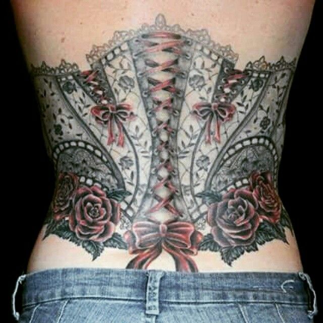 the back of a woman's body with tattoos on her lower and lower back