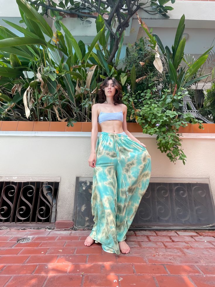 Elevate your vacation wear with our Summer Tie-Dye Wide-Leg Pants. Crafted from 100% Rayon for maximum breathability and a fluidic drape, they keep you cool and light as air throughout the season. An elasticated drawstring waist delivers an adjustable fit, while side pockets add a practical touch. The vibrant tie-dye patterns capture the essence of summer, granting your holiday looks a mesmerizing flair. Features: Handmade Tie-dyed by hand Drawstring elastic waistline Lightweight feel Quick-dryi Dye Pants, Dye Patterns, Summer Ties, Summer Tie Dye, Tie Dye Pants, Indigo Colour, Vacation Wear, Cool Ties, Indigo Dye