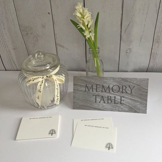 there is a vase with flowers in it next to a sign that says memory table