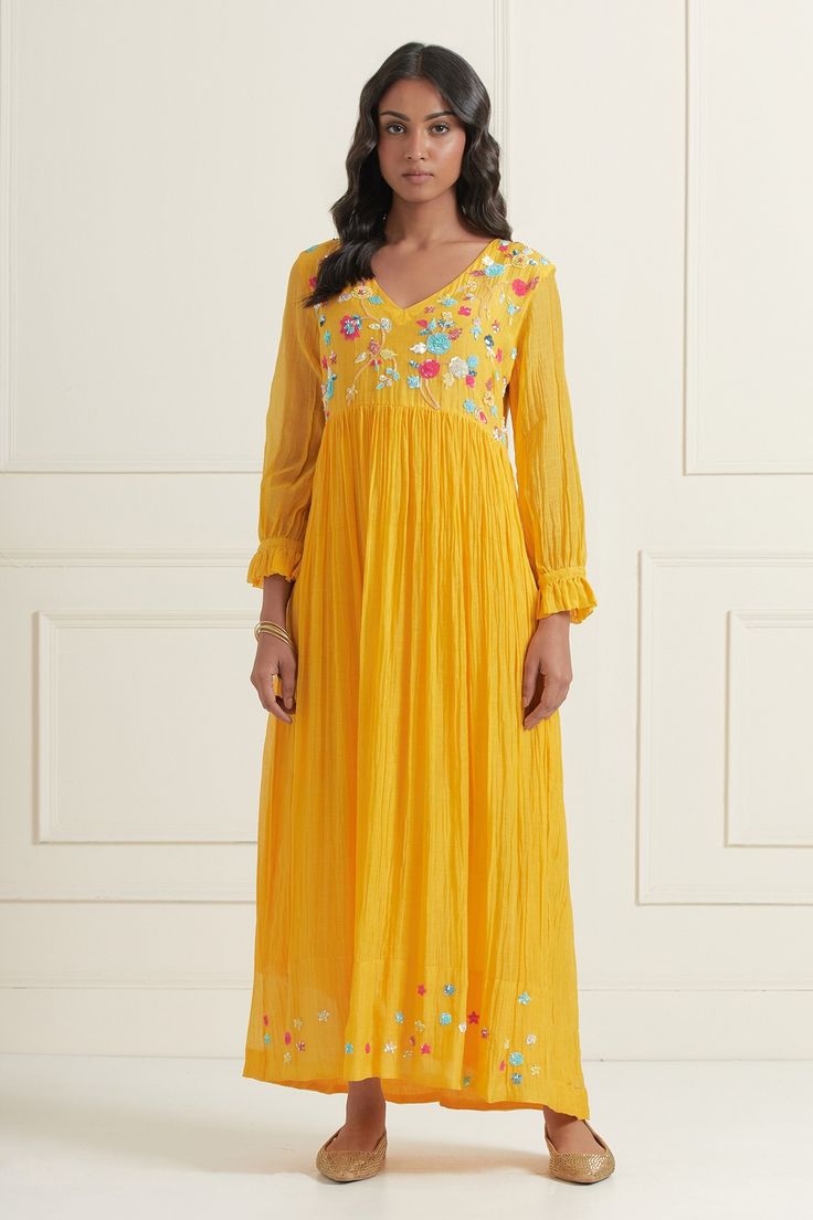 Yellow chaderi fit and flare dress with sequin floral embroidered motifs.
Component: 1
Pattern: Embroidered
Type Of Work: Floral
Neckline: V-Neck
Sleeve Type: Puff
Fabric: Chanderi
Color: Yellow
Other Details: 
Hand embroidered front and back yoke
Pleated sleeve detail
Occasion: Resort,Party - Aza Fashions Festive V-neck Dress With Resham Embroidery, Long Sleeve Embellished Chanderi Dress, Semi-stitched V-neck Dress For Festive Occasions, Semi-stitched V-neck Festive Dress, Navratri Embroidered Straight Kurta Dress, Semi-stitched Anarkali Dress With Floral Embroidery, Semi-stitched Floral Embroidered Dress For Navratri, Floral Embroidered Semi-stitched Dress For Navratri, Semi-stitched Floral Embroidery Dresses For Navratri